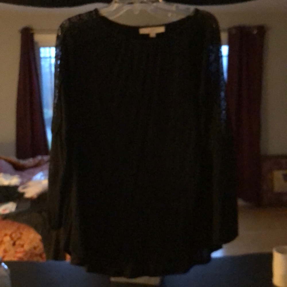 Black long sleeve top with lace down the sleeves. 100% rayon. Good condition.